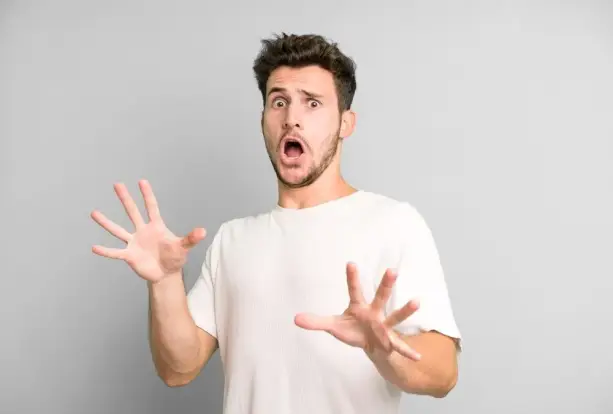 شخص تظهر عليه علامات القلق والتوتر أثناء جلوسه في مقهى مزدحم بالناس